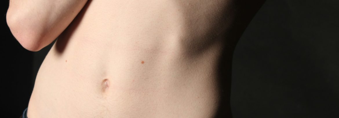 person wearing blue denim bottom's navel